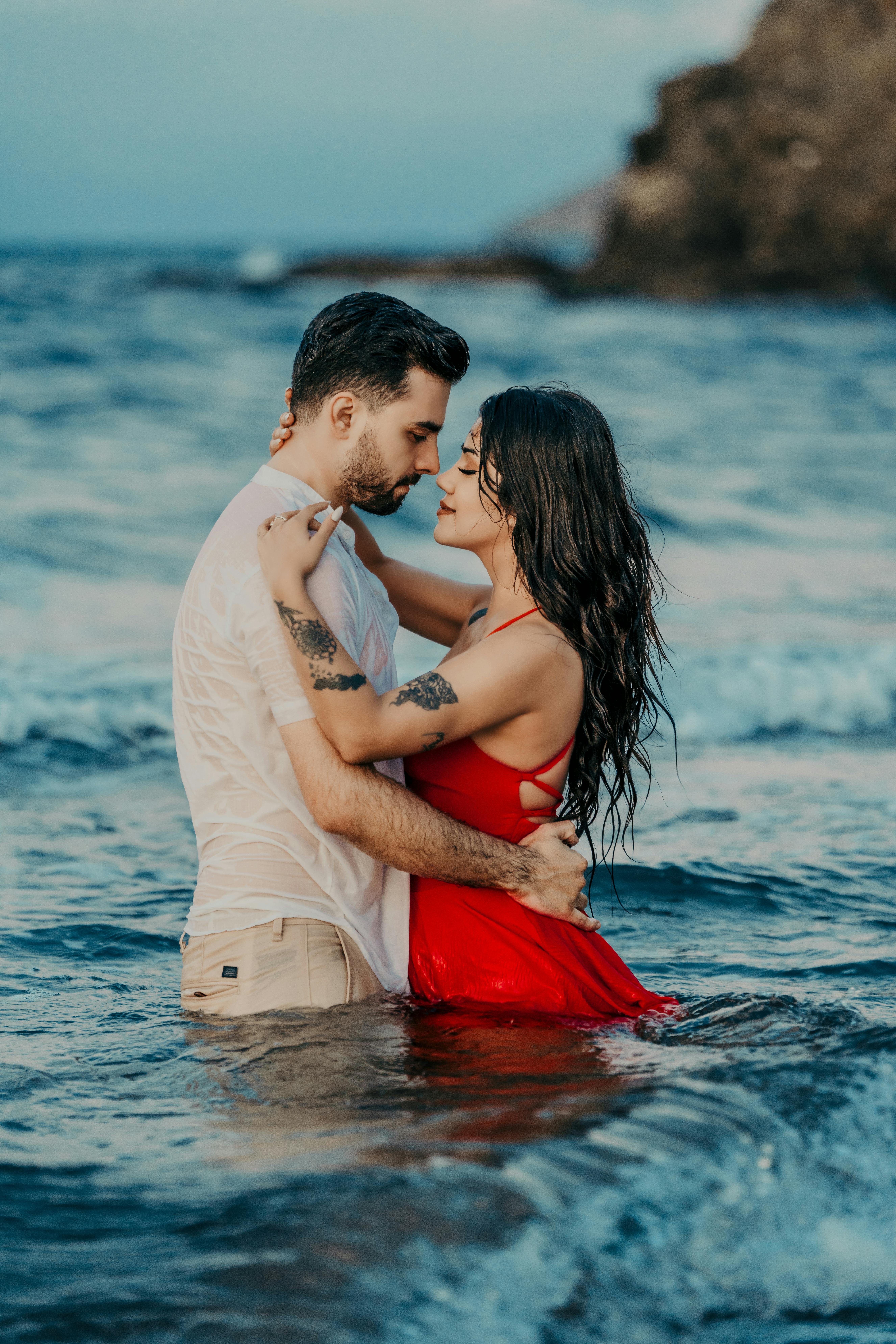 Couple embracing in the ocean during a romantic beach escape